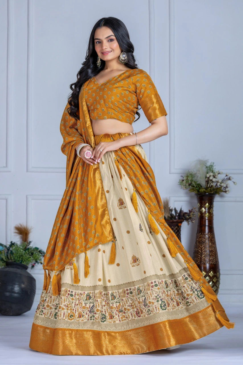 Woman wearing a mustard yellow and beige saree with a white wall background